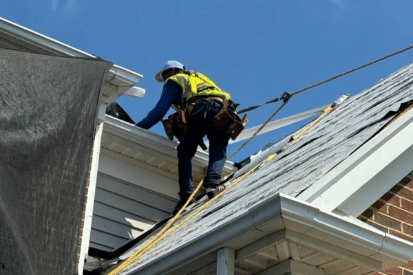 construction worker on the roof of a house