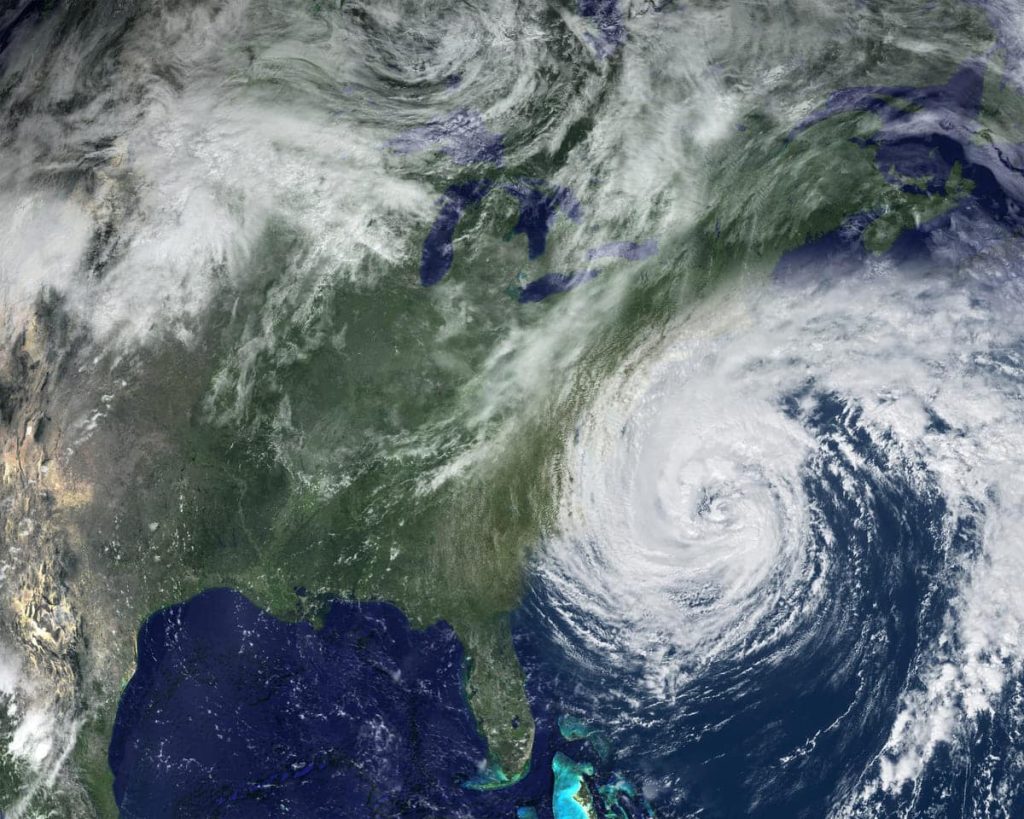Satellite image of a hurricane approaching the East Coast of the United States near North Carolina, highlighting storm formation over the Atlantic Ocean and potential impact zones including Raleigh, Durham, Chapel Hill, Greensboro, Charlotte, North Carolina and the Southeast